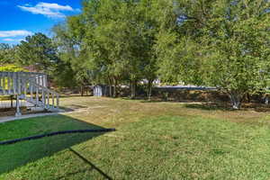 View of yard featuring a storage unit