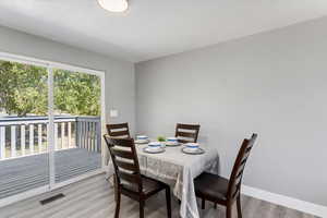 Dining room with light hardwood / wood-style flooring