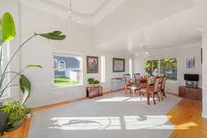 Dining area featuring ornamental molding, light hardwood / wood-style floors, and a chandelier