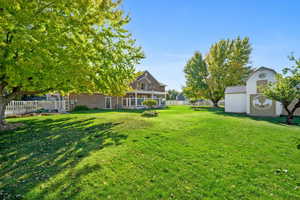 View of yard featuring a shed and fenced yard.