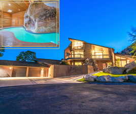 View of front of home featuring a garage and a balcony