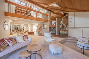 Living room featuring high vaulted ceiling, beam ceiling, and wooden ceiling