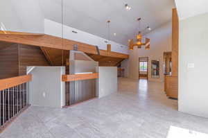 Kitchen with pendant lighting and high vaulted ceiling