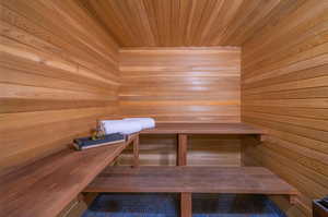 View of sauna featuring wooden walls and wood ceiling