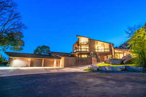 View of front of property with a balcony and a garage