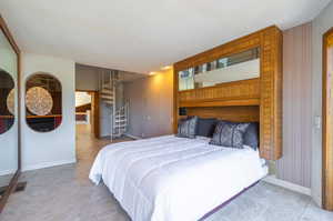 Bedroom featuring wooden walls and a textured ceiling