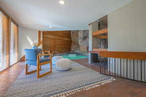 Living area with wooden walls and a swimming pool