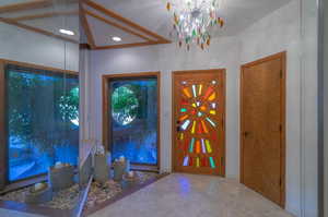 Entrance foyer with an inviting chandelier and ornamental molding