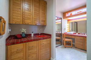 Kitchen with tile countertops and sink