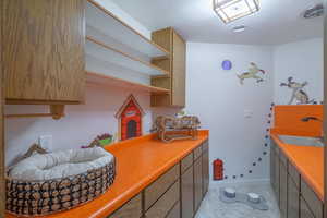 Kitchen with light colored carpet and sink