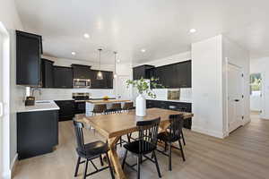 Dining area featuring sink and light hardwood / wood-style floors