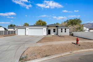 View of front of property with a garage and a mountain view