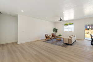 Sitting room featuring ceiling fan and light hardwood / wood-style floors