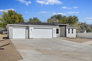 View of front of home featuring a mountain view and a garage