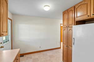 Kitchen featuring white fridge with ice dispenser