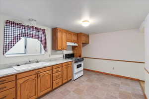 Downstairs 2nd Kitchen with white range oven and sink