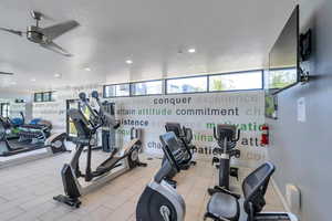 Workout area featuring a textured ceiling and ceiling fan