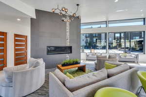 Living room with a textured ceiling and a tiled fireplace