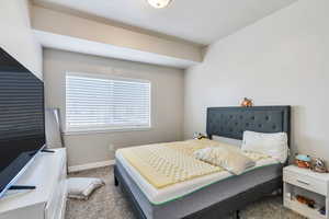 Bedroom featuring carpet floors and a textured ceiling