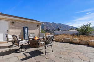 View of patio / terrace featuring a fire pit and a mountain view