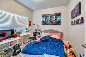 Bedroom featuring a textured ceiling and carpet flooring