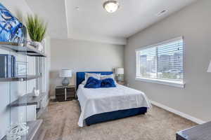 Carpeted bedroom with a textured ceiling