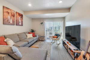 Living room featuring a textured ceiling and hardwood / wood-style flooring