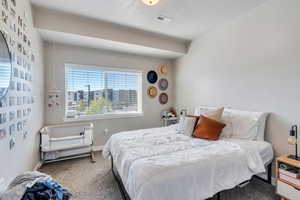 Carpeted bedroom with a textured ceiling