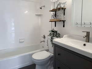 Full bathroom with shower / tub combination, vanity, and toilet