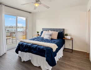 Bedroom with access to exterior, wood-type flooring, ceiling fan, and a water view