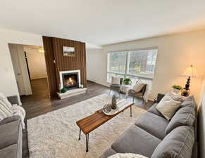 Living room featuring dark wood-type flooring and a fireplace