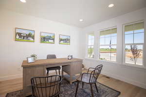 Office space with hardwood / wood-style flooring