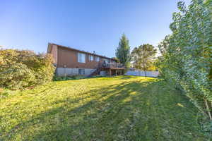 View of yard featuring a deck and central AC