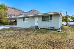 View of front of home featuring a front lawn and a mountain view