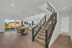 Stairs with hardwood / wood-style flooring