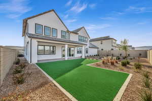 Rear view of house featuring a yard, central AC unit, and a patio area