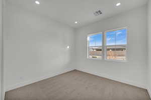 Empty room featuring light carpet