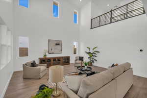 Living room featuring hardwood / wood-style floors and a high ceiling