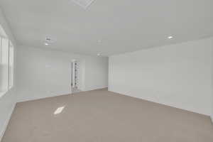 Unfurnished room featuring light colored carpet