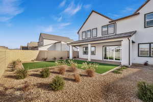 Rear view of house featuring a lawn