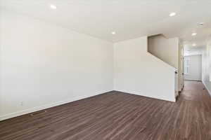 Spare room with dark hardwood / wood-style flooring