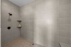 Bathroom featuring tiled shower