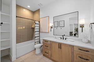 Full bathroom featuring vanity, tile patterned floors, toilet, and shower / bathtub combination with curtain