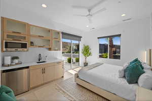 Tiled bedroom with access to exterior, sink, and refrigerator