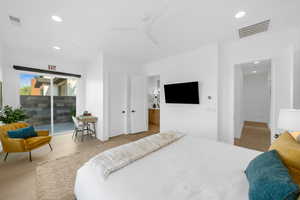 Bedroom featuring light tile patterned flooring, ceiling fan, and access to outside