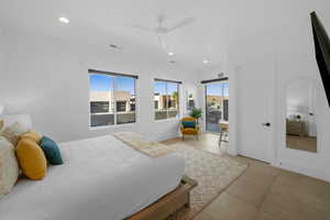 Bedroom featuring access to outside, ceiling fan, and light tile patterned flooring