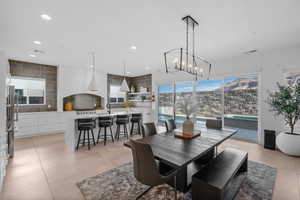 Tiled dining area featuring sink