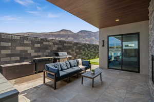 View of patio featuring area for grilling, outdoor lounge area, and a mountain view