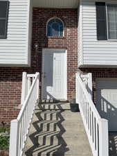 View of exterior entry with a garage