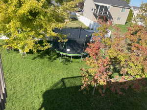 View of yard with a trampoline